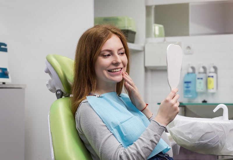 Dentist Examining Girl's Teeth in Clinic for Full Mouth Recostruction Surgery in Los Gatos, CA